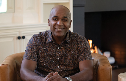 man sitting in a chair and smiling